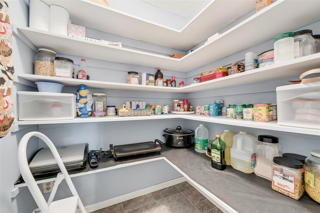 646 Liska Road Ennis, TX 75119 - Photo 8 of 23 a room with storage and a shelf