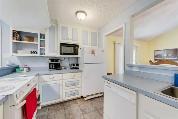 a kitchen with cabinets appliances and a sink