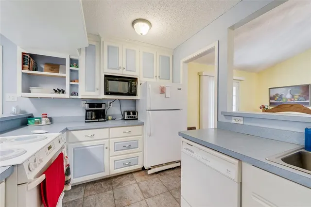 a kitchen with cabinets appliances and a sink