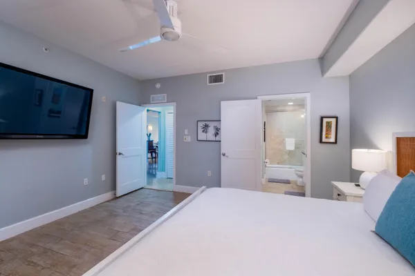 a bathroom with a granite countertop sink a toilet a mirror and shower