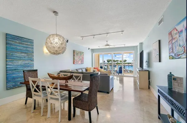 a kitchen with stainless steel appliances a refrigerator a sink and white cabinets