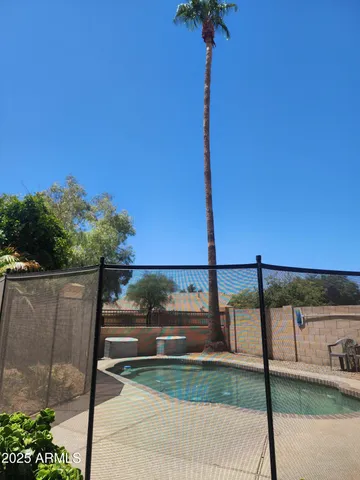 a street sign on a sidewalk next to a road