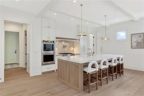 a large kitchen with a table and chairs