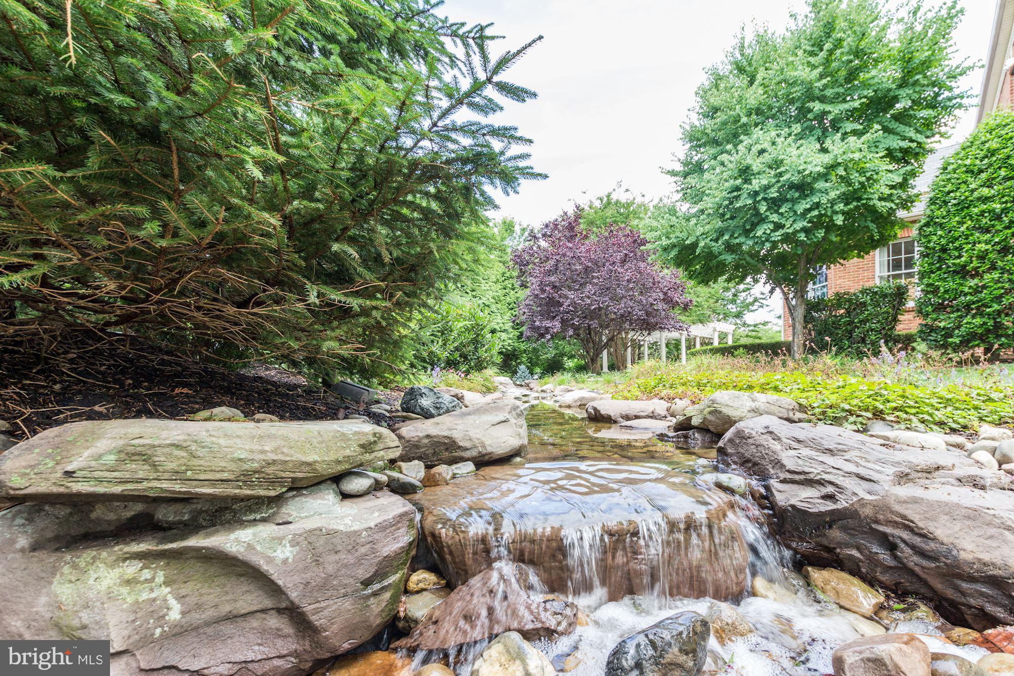 10600 Rivers Bend Lane Potomac, MD 20854 - Photo 40 of 42 Calming Recirculating River Rock Stream Bed