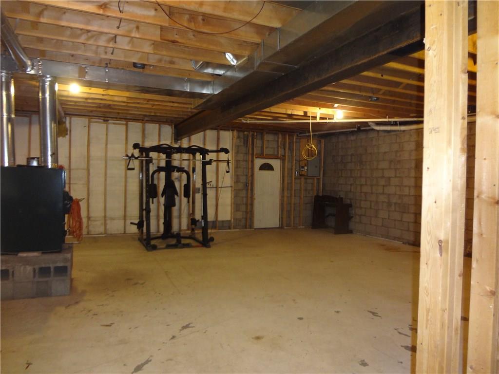 954 Achortown Road Beaver Falls, PA 15010 - Photo 13 of 25 Lower Level Framed-In Family Room Area With Woodburner and Man Door to Lower Level Garage