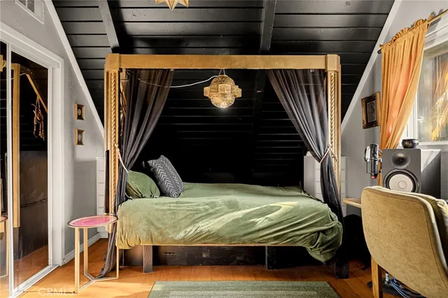 a bedroom with a bed and chair
