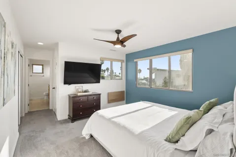 a bedroom with a bed and a flat screen tv