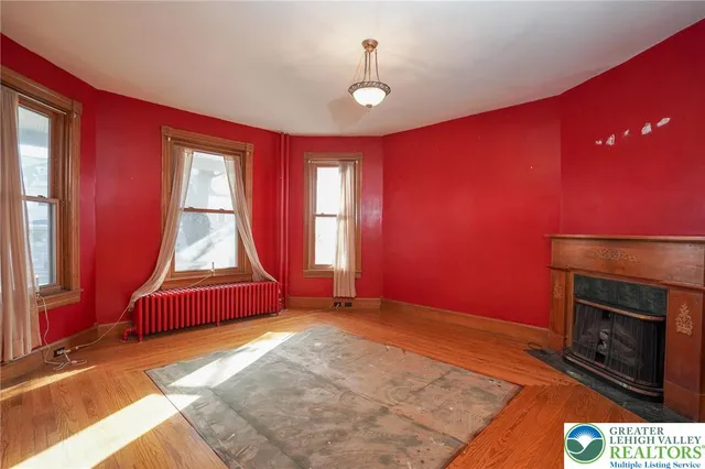 a view of a livingroom with a chandelier fan and a window
