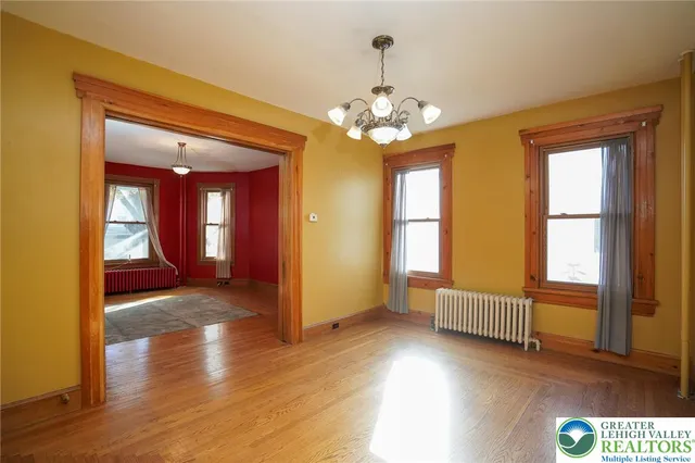 a kitchen that has a sink window and cabinets
