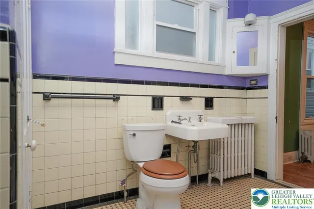 a view of hallway with a large window and chandelier