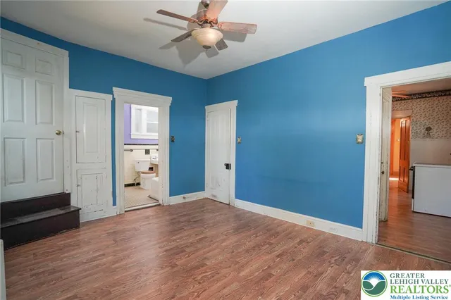 an empty room with windows and closet