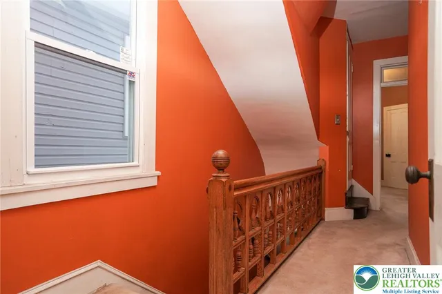 an empty room with a ceiling fan and a window