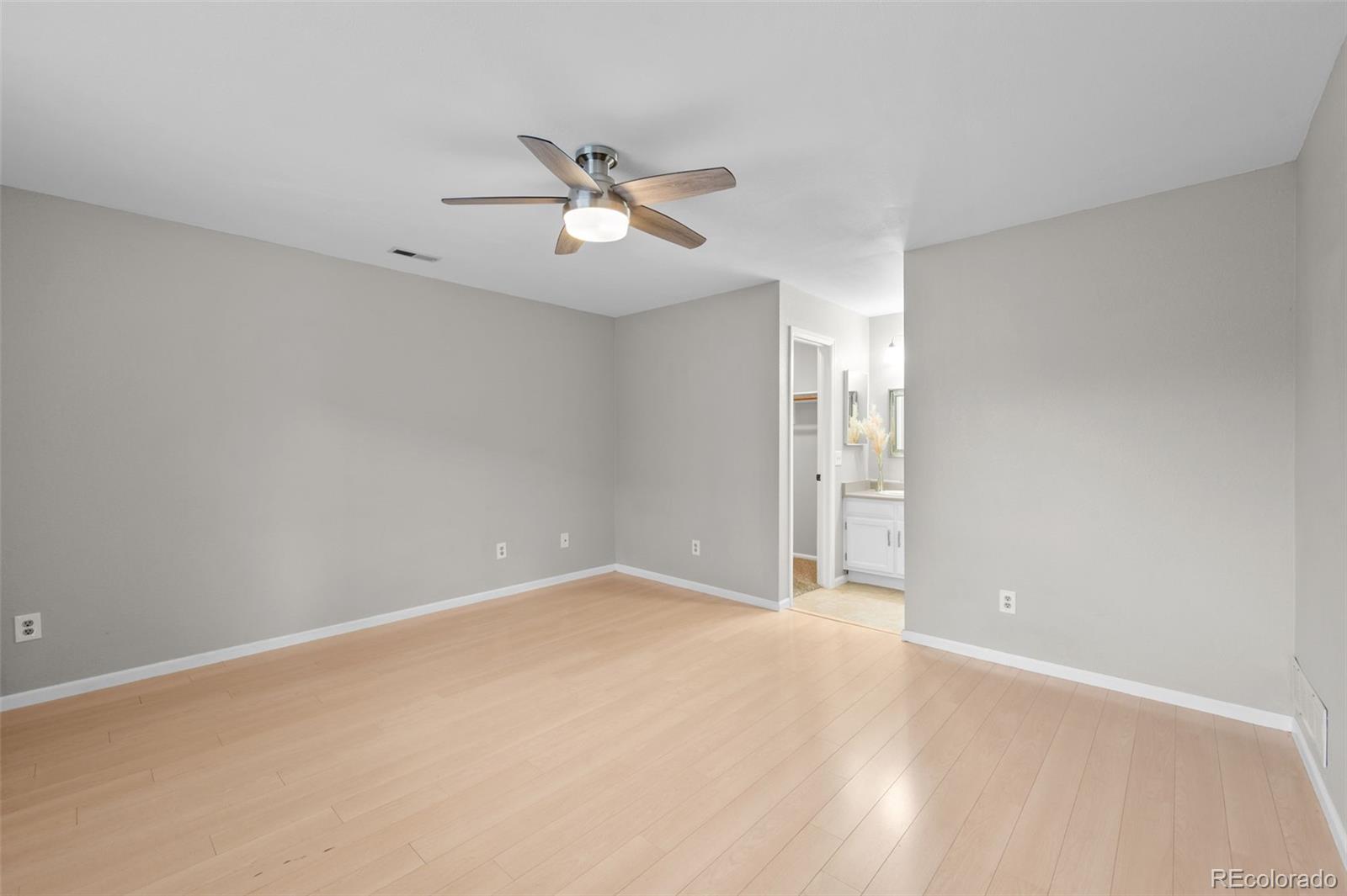 9409 West 89th Circle Broomfield, CO 80021 - Photo 12 of 22 a view of an empty room with chandelier fan
