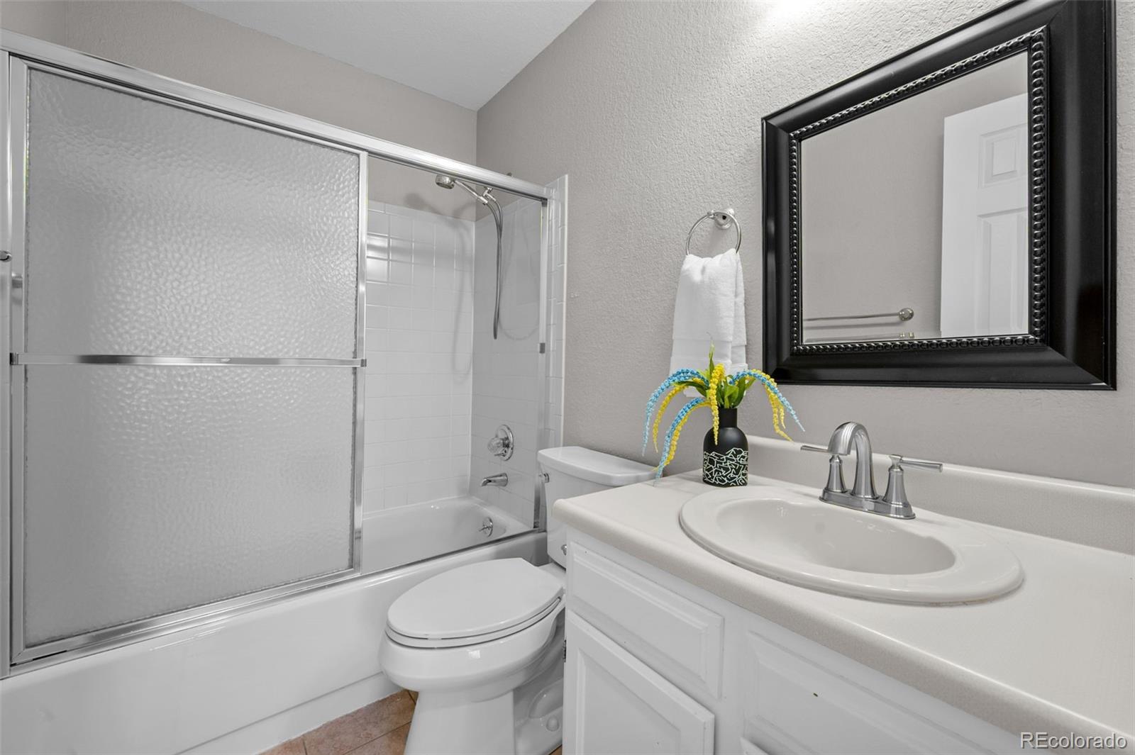 9409 West 89th Circle Broomfield, CO 80021 - Photo 17 of 22 a bathroom with a sink toilet and shower