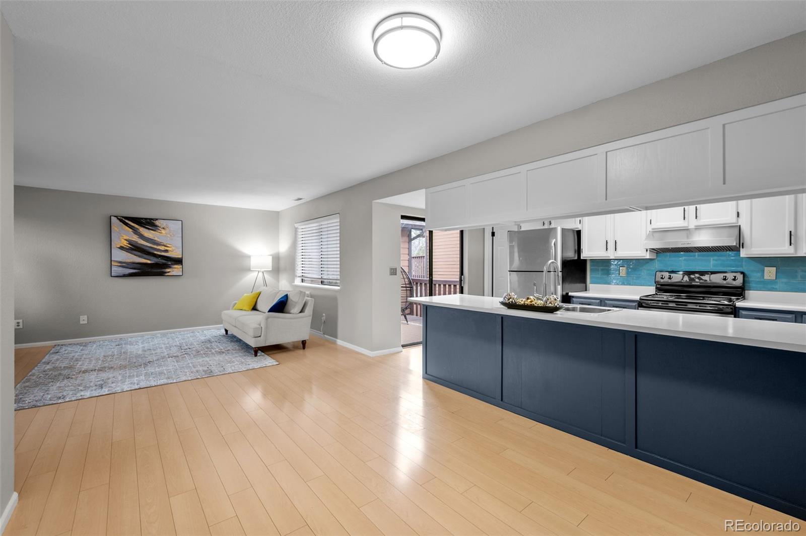 9409 West 89th Circle Broomfield, CO 80021 - Photo 2 of 22 a kitchen with stainless steel appliances granite countertop a sink dishwasher stove top oven and cabinets with wooden floor
