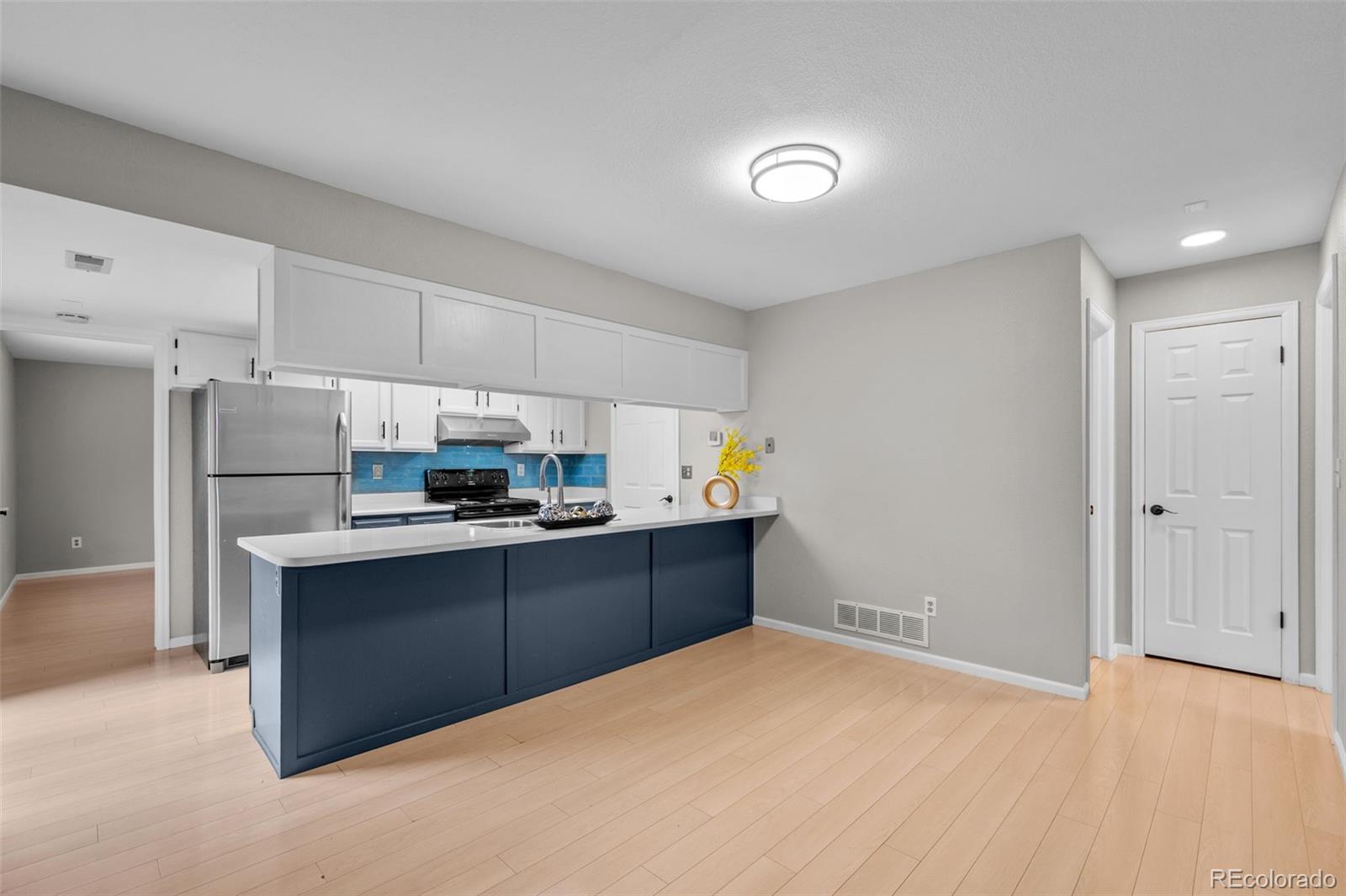 9409 West 89th Circle Broomfield, CO 80021 - Photo 6 of 22 a kitchen with stainless steel appliances a refrigerator and a stove top oven