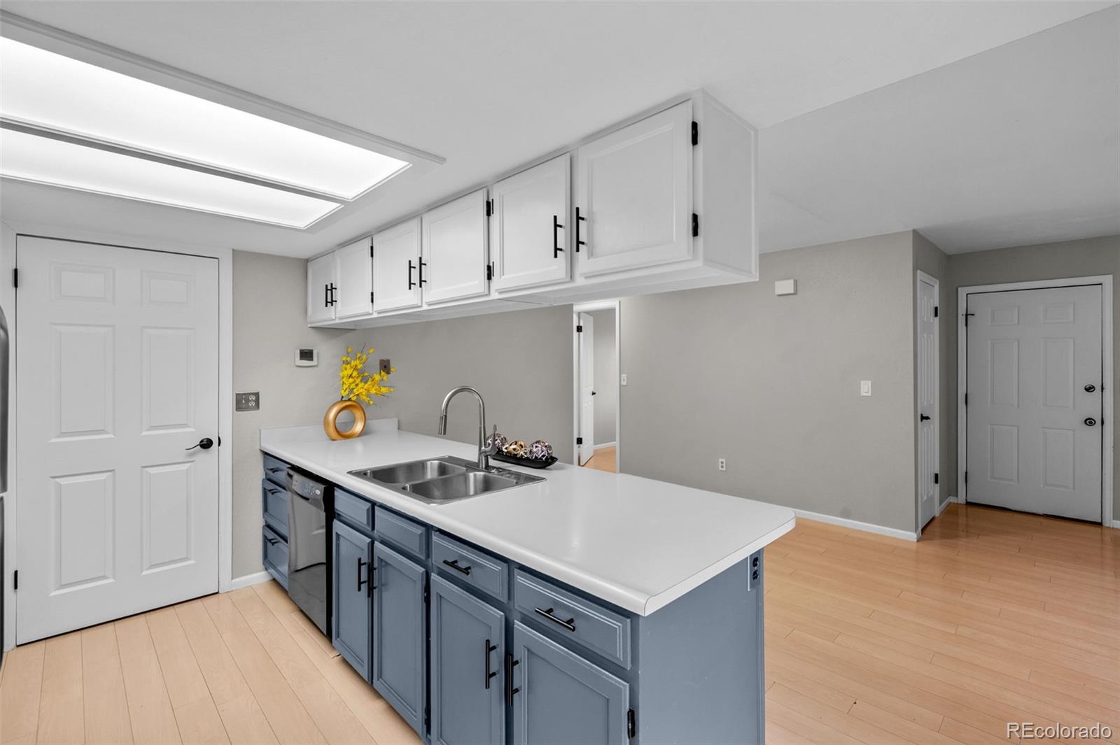 9409 West 89th Circle Broomfield, CO 80021 - Photo 9 of 22 a kitchen with stainless steel appliances granite countertop a sink stove and cabinets