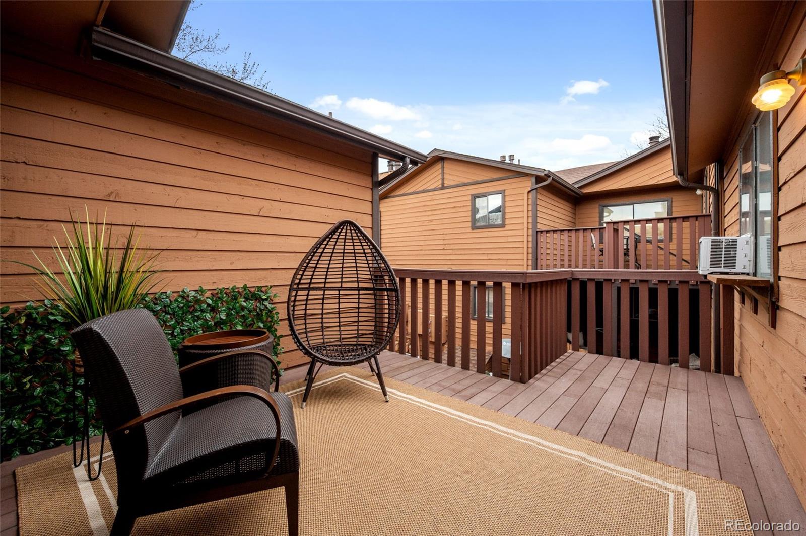 9409 West 89th Circle Broomfield, CO 80021 - Photo 10 of 22 a view of balcony with furniture and wooden floor