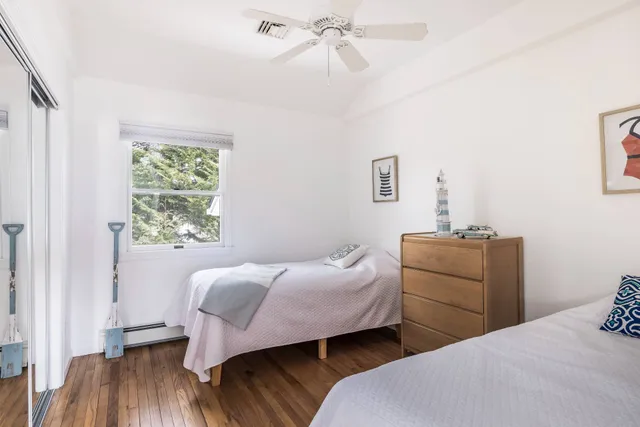 a bedroom with two beds and a window