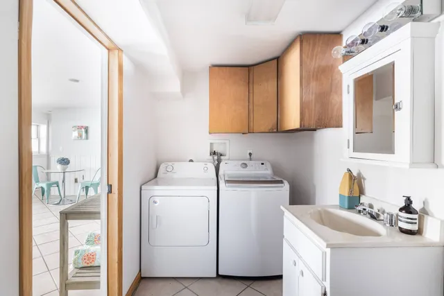 a utility room with sink dryer and washer