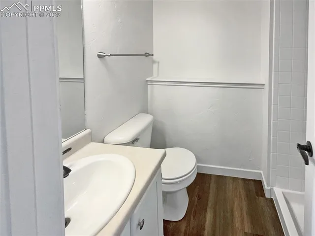 a white toilet sitting next to a bathroom sink