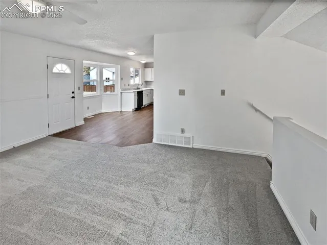 a view of a kitchen with a refrigerator and a sink