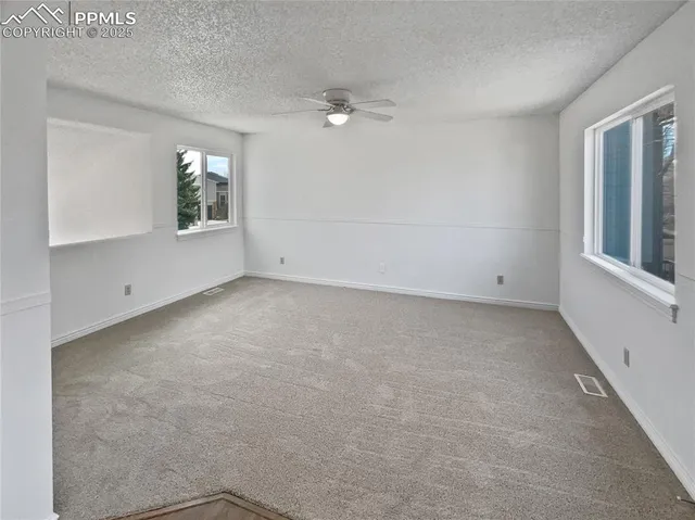 an empty room with windows and closet