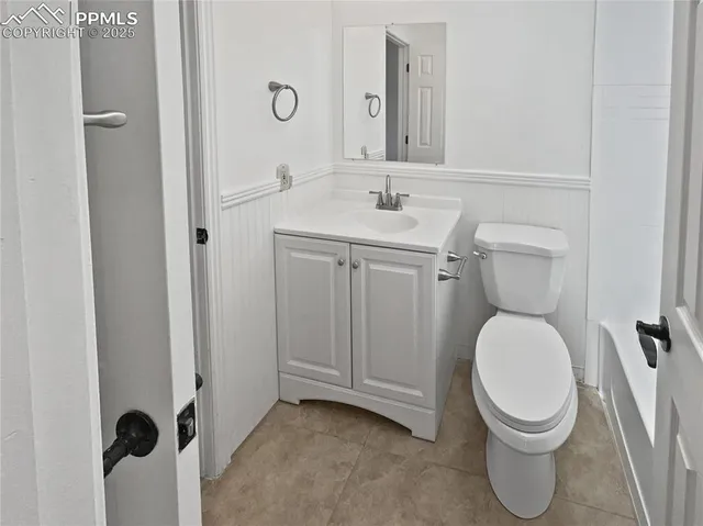a bathroom with a toilet sink and a mirror