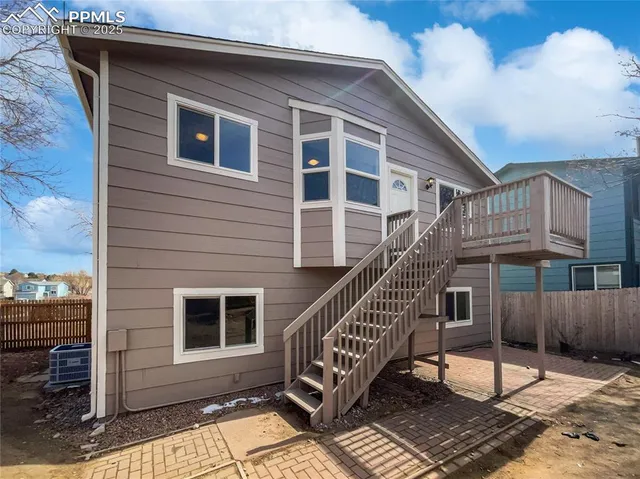 a view of a house with a wooden deck