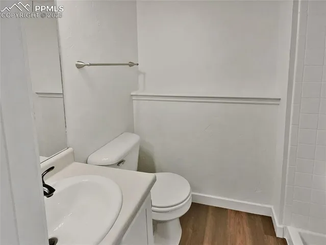 a white toilet sitting next to a bathroom sink