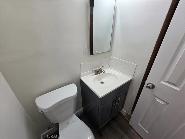 a white toilet sitting next to a bathroom sink