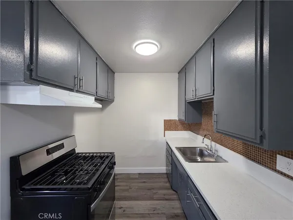 a kitchen with a stove and a sink