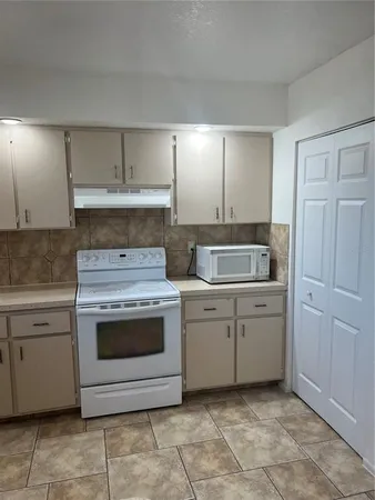 a kitchen with a stove and a sink