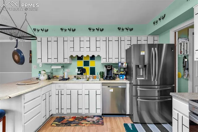 a kitchen with stainless steel appliances granite countertop a sink and cabinets