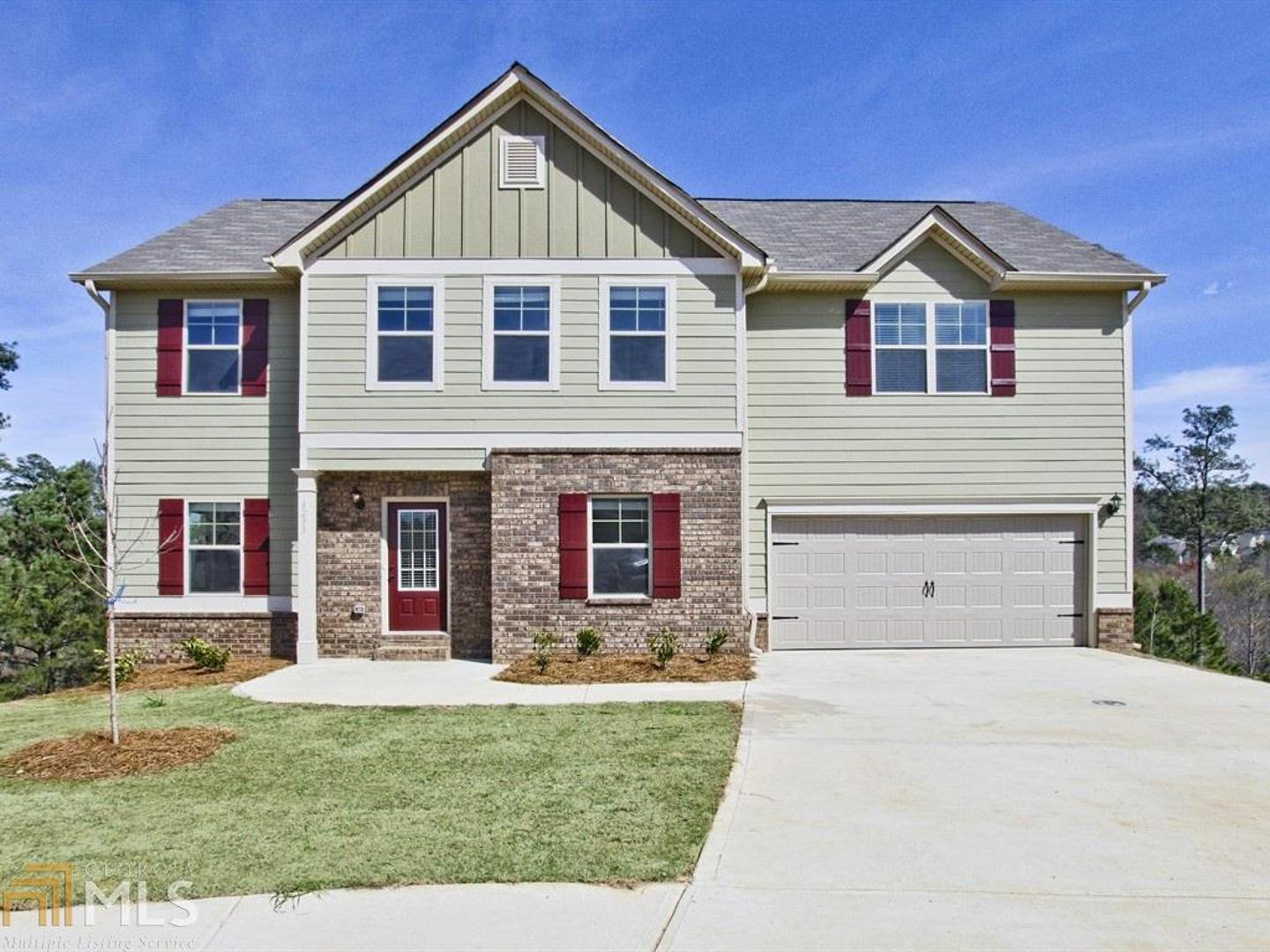 868 Potomac Walk Road, Unit 185 Loganville, GA 30052 - Photo 1 of 1 a front view of a house with a yard and garage
