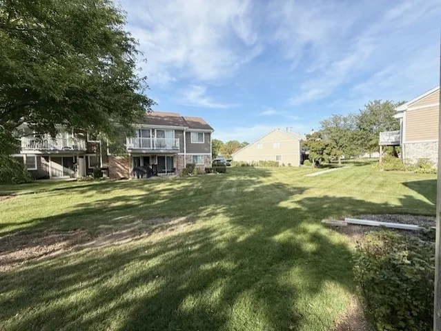 a view of a big yard with large trees