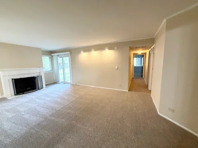 a view of empty room with a fireplace