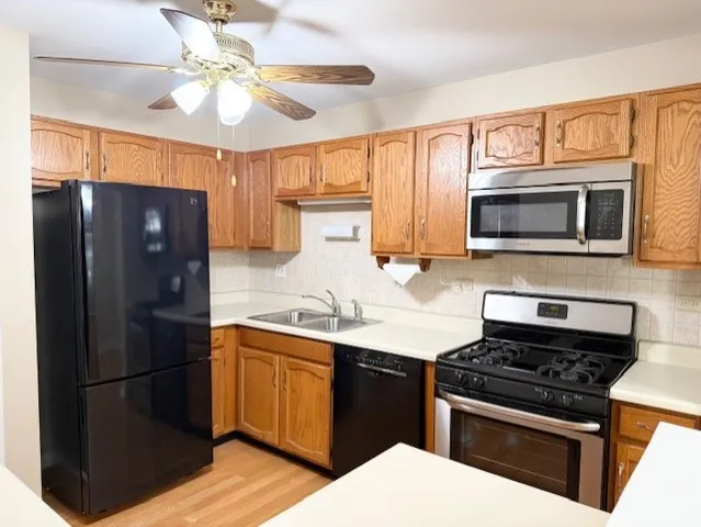 a kitchen with a refrigerator stove and microwave
