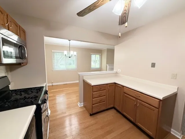 a kitchen with a sink a stove and microwave