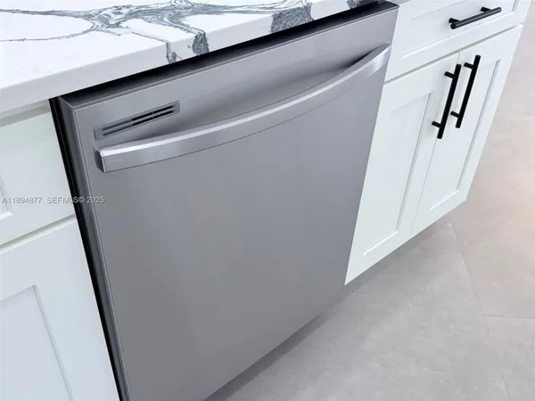 a kitchen with stainless steel appliances kitchen island a stove a refrigerator a oven a sink with a dining table and chairs