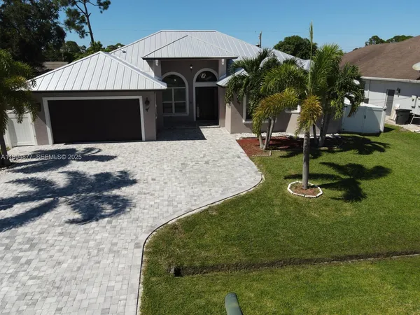a front view of a house with garden