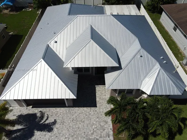 an aerial view of residential houses with outdoor space and swimming pool