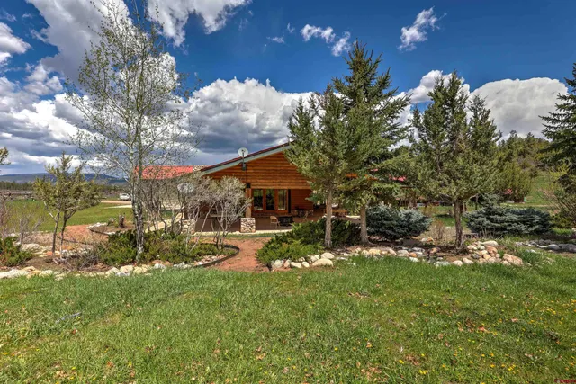 a view of a house with floor to ceiling windows and a basket ball poll