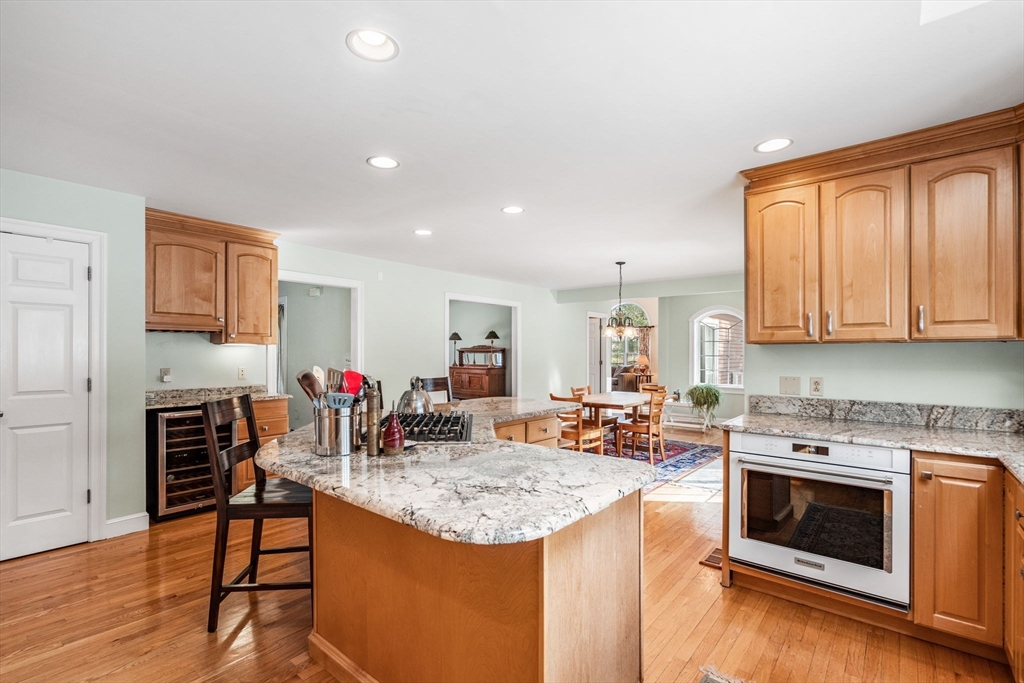 37 Fellows Road Ipswich, MA 01938 - Photo 9 of 42 a kitchen with stainless steel appliances granite countertop a stove top oven a sink dishwasher and a refrigerator with wooden floor