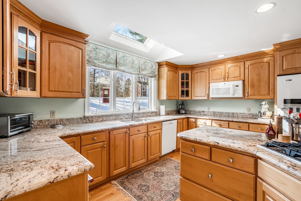 37 Fellows Road Ipswich, MA 01938 - Photo 10 of 42 a kitchen with granite countertop sink stove and cabinets