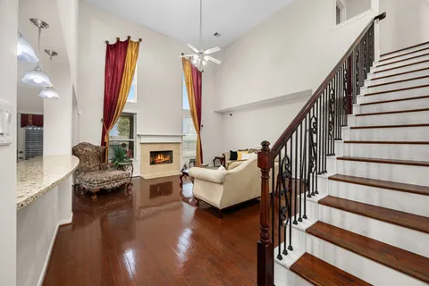 a living room with fireplace furniture and a wooden floor