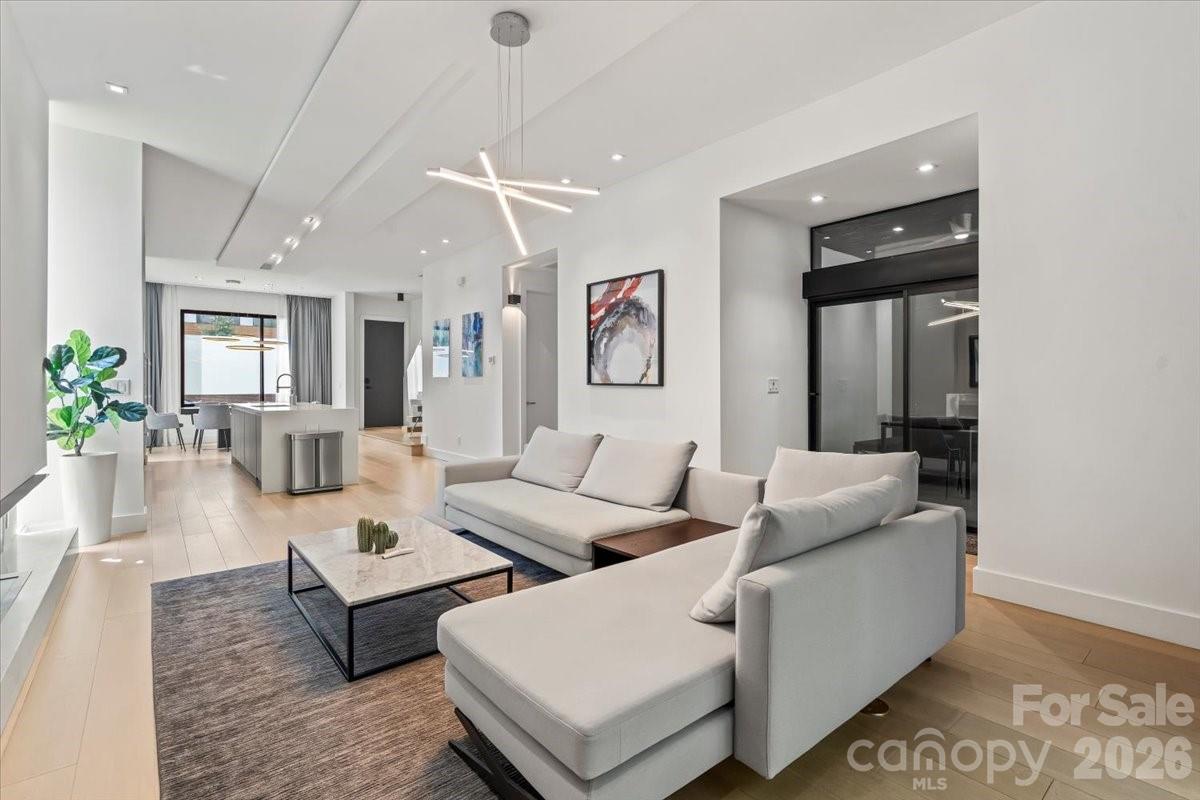 1620 South Tryon Street Charlotte, NC 28203 - Photo 4 of 29 a living room with furniture and a chandelier