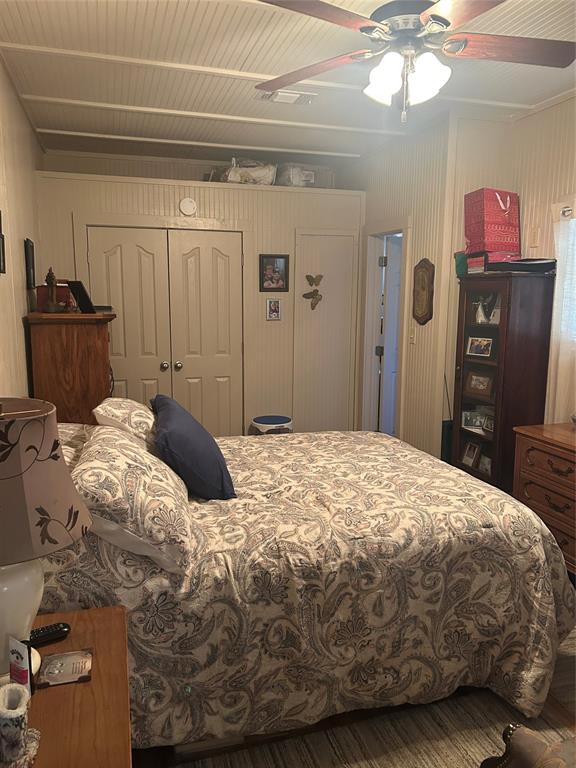 244 County Road 1973 Yantis, TX 75497 - Photo 13 of 16 a bedroom with a bed and a chandelier