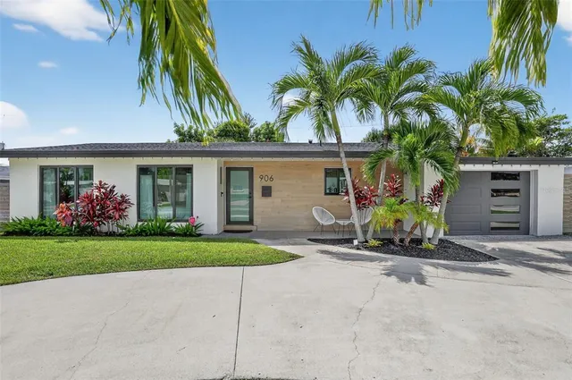 a front view of house with yard and outdoor seating
