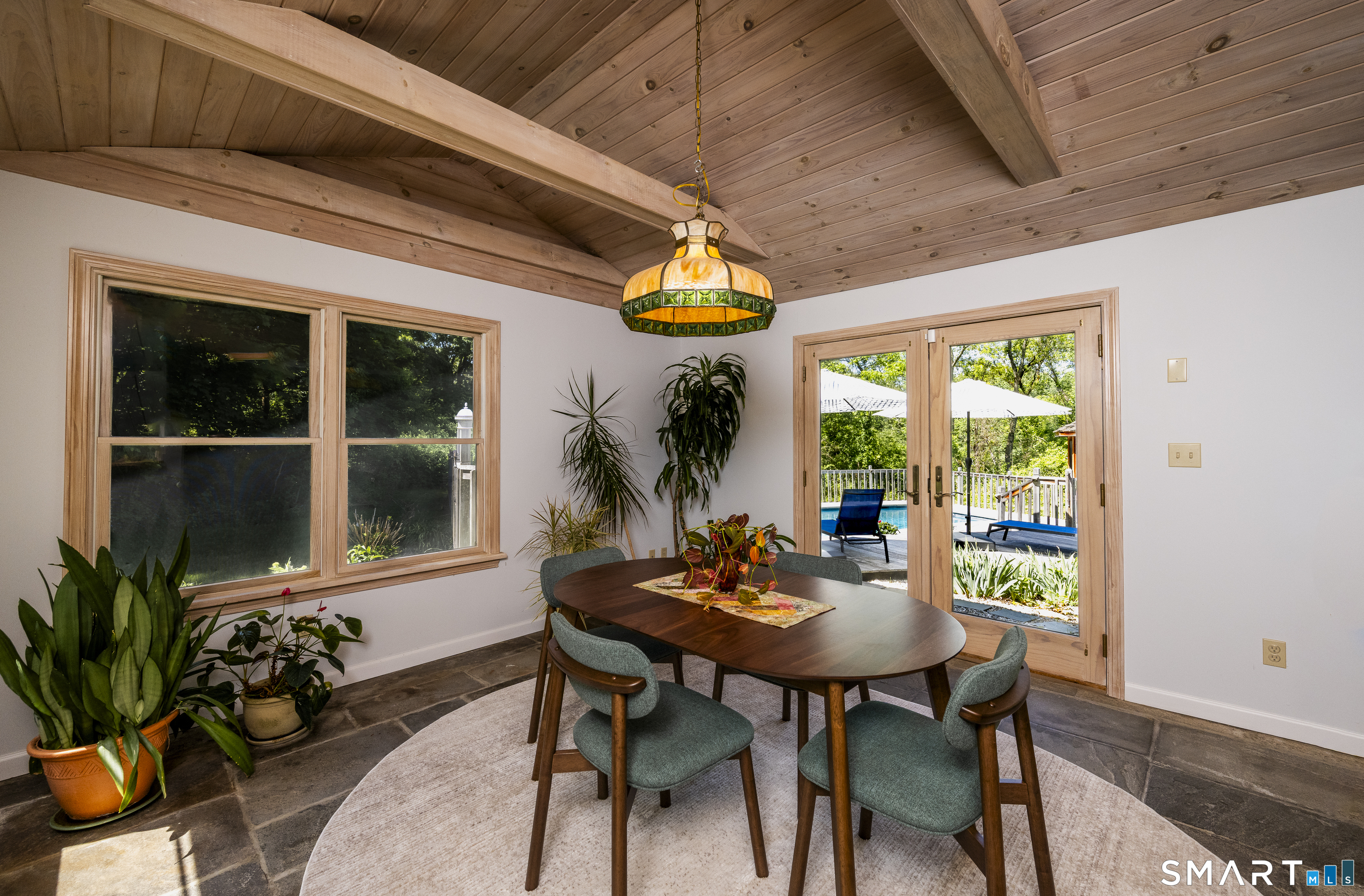 7 Chimney Rock Road Kent, CT 06757 - Photo 15 of 35 a view of a porch with dining table and chairs
